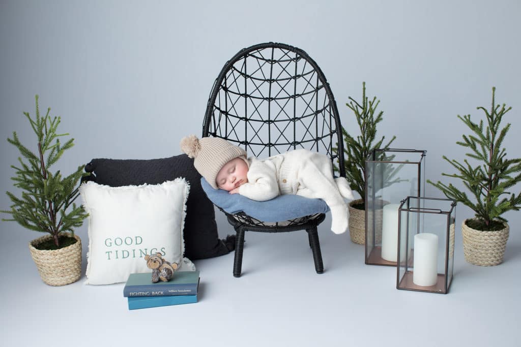 Christmas newborn photography of a sleeping baby wearing a Santa hat