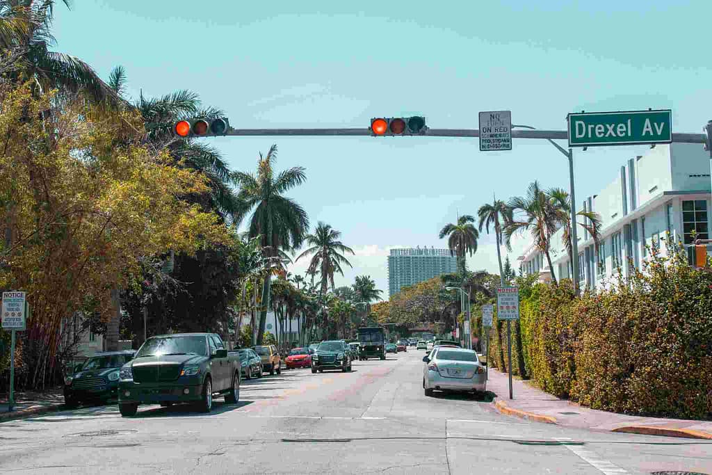 Illustration showing a red light camera at an intersection in Florida with cars stopping at a red signal – Are Red Light Cameras Legal in Florida.
