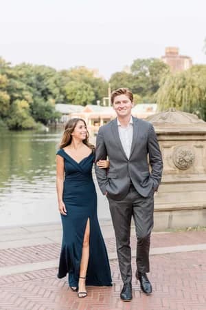 “Couple laughing near Bethesda Fountain during their Central Park engagement session”