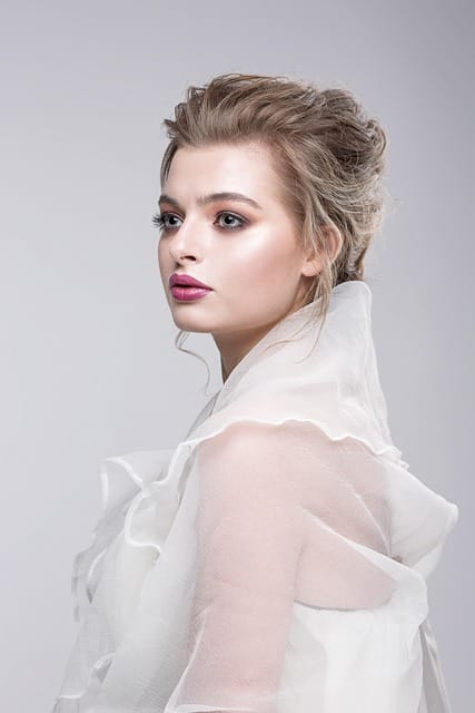 Woman with natural makeup and styled hair posing for headshot
