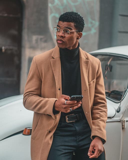 A well-dressed man posing near a luxury car demonstrating fashion photo composition techniques
