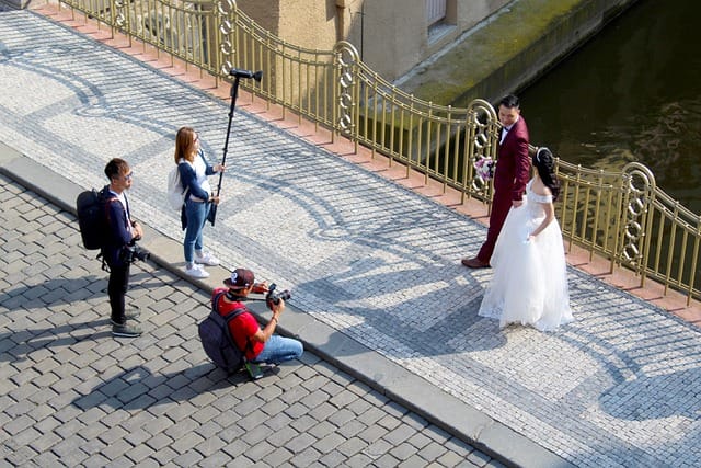 Wedding photographer capturing romantic moments of a couple on their wedding day outdoors.