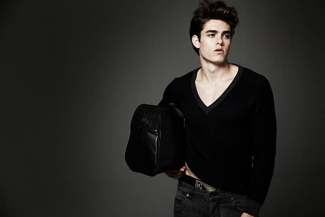 Professional male model headshot of a man posing against a black background