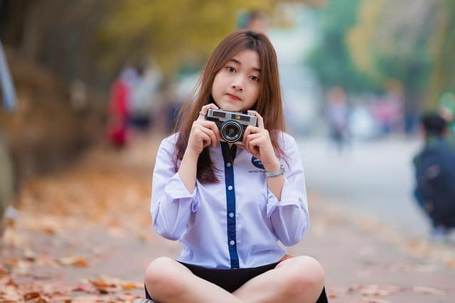 Girl experimenting with camera angles for a creative photo