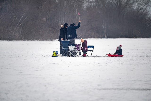 Family enjoying outdoor winter family photography session on snow field
