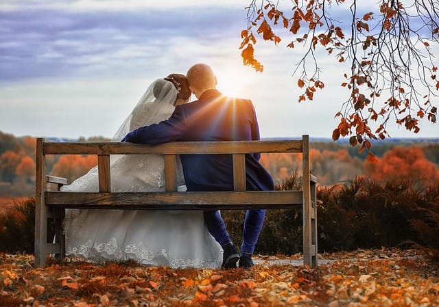 Professional photographer taking fall wedding photos at sunset